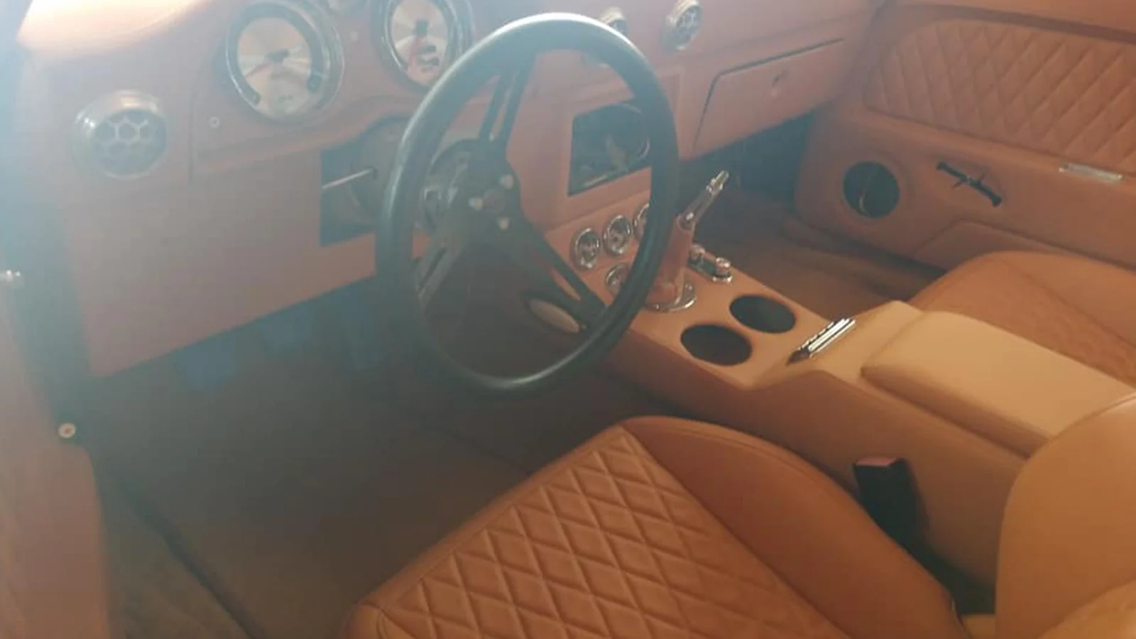 Custom tan Camaro interior with steering wheel and center console
