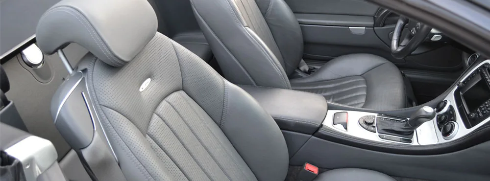 Detailed gray leather vehicle seats and center console