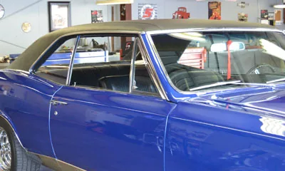 Blue classic car with a vinyl roof